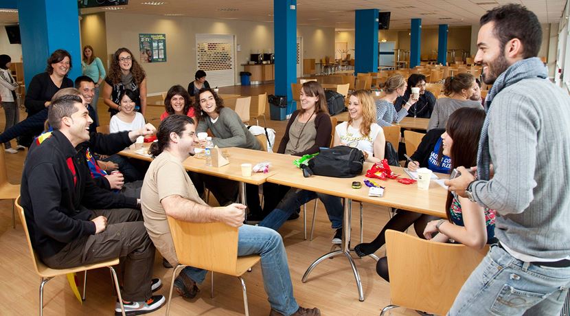 Group of students enjoying their lunch break in a canteen.
