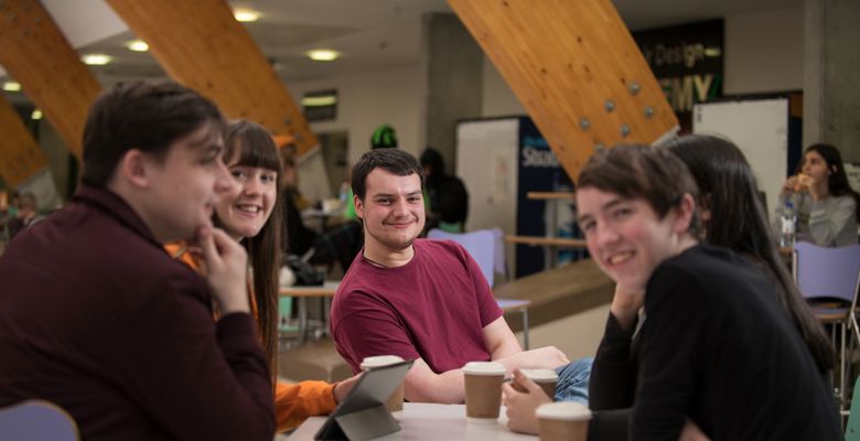 Group of students working together at a table on campus.