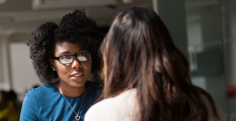 Two people speaking to each other during an interview.