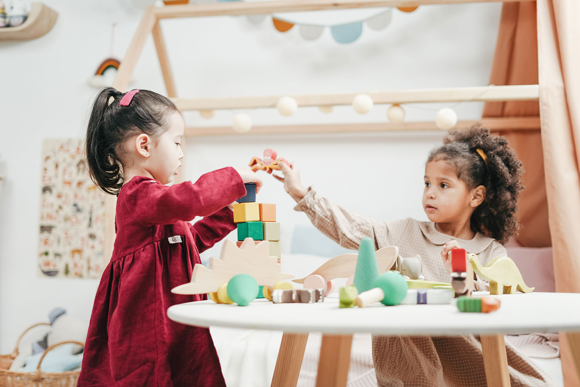 Two young children playing with blocks in a nursery.