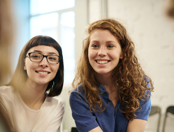 Two students smiling.