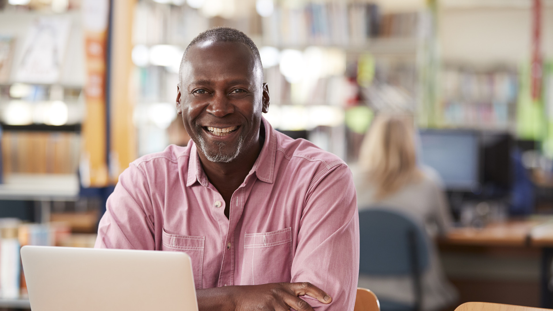 Mature student studying in the library.