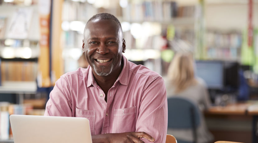 Mature student studying in the library.