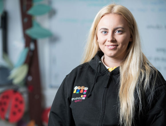 Childhood practice smiling in their classroom.