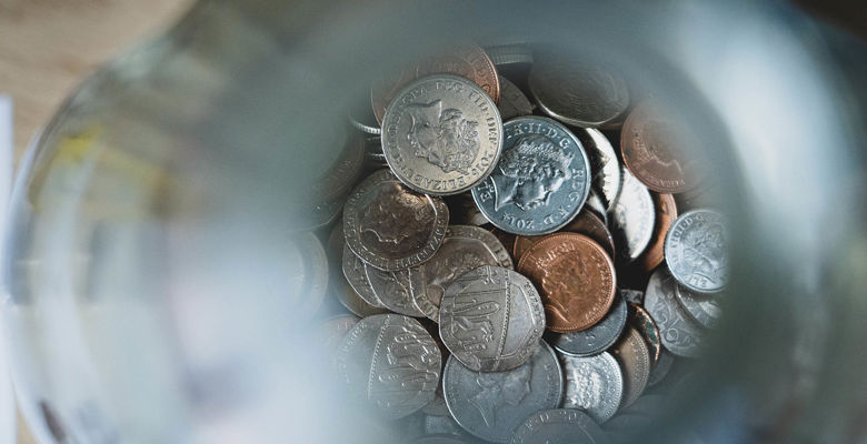 Pot of money with coins at the bottom.