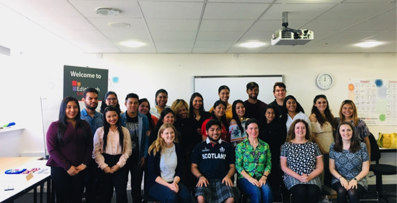 Group of English Language Teaching students posing for a photo in a classroom.