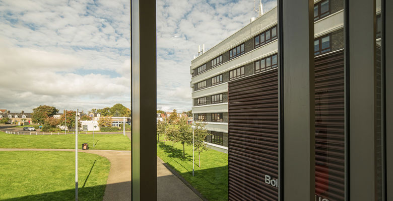 Looking out a window on a sunny day at Milton Road campus.